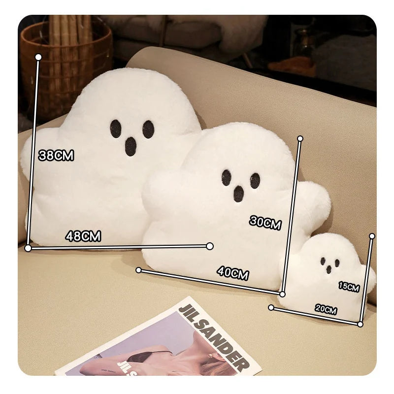 Set of ghost-shaped plush toys with measurements on a table